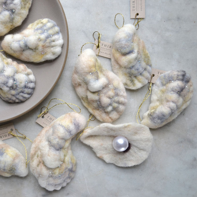 Decorative oyster shells with pearls on a marble surface